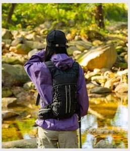 Black outdoor hiking backpack detail, durable waterproof fabric with multi-strap design for sports.
