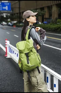 Detailed view of the casual green travel backpack, showing its large capacity and straps.