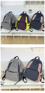 Detail view of multi-color casual school backpacks showing front zippered pockets and color blocks.