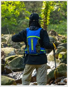 Outdoor hiking backpack detail shot, blue and black vest design with green zipper accents.