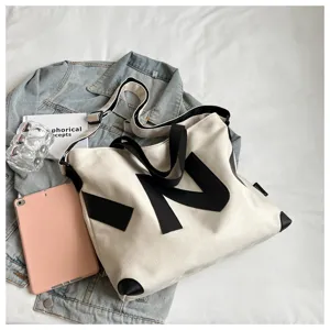 Canvas tote bag for women, stylish Japanese aesthetic shoulder bag with casual design and ample space.
