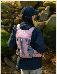 Pink hiking backpack with multiple pockets and straps, outdoor sports gear detail view.