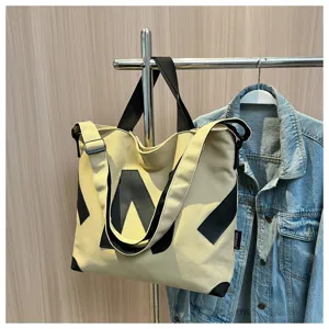 Canvas tote bag for women, stylish Japanese student shoulder bag with contrast black geometric design.