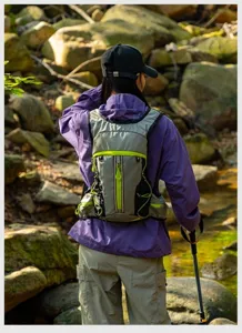 Outdoor hiking backpack detail shot showing breathable vest straps and convenient zipper pockets.