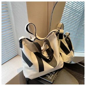 Detailed view of Japanese style canvas tote shoulder bag with contrast black straps and minimalist design.