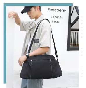 Detailed shot of a versatile black travel and gym shoulder bag worn by a model outdoors.