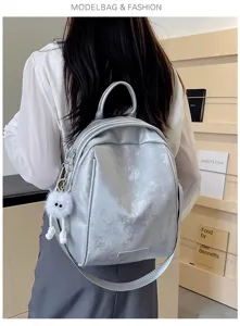Stylish silver backpack with large capacity for women commuting and daily travel use.