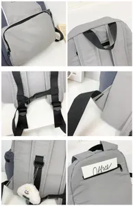 Detailed view of grey canvas backpack showing durable straps, zippers, and cute plush pendant.