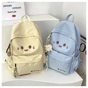 Cute cartoon canvas backpack with plush charm, ideal for casual travel and daily school use.