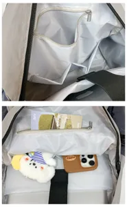 Backpack interior detail showing multiple compartments, zipper pocket and spacious storage design.