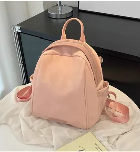 Close-up view of the pink women backpack showing smooth surface and zipper details.