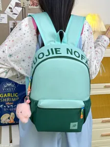 Sac à dos tendance color-block pour étudiants avec grande capacité et joli pendentif.