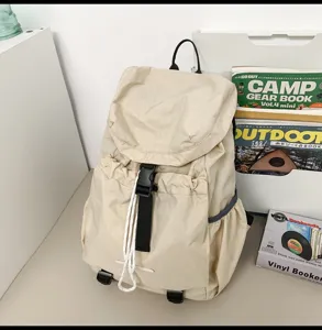Detail view of the lightweight beige canvas casual backpack with drawstring and buckle closure.