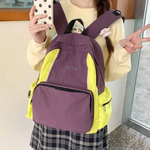 Stylish purple and yellow colorblock backpack for students, lightweight daily casual school bag.