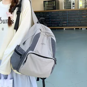 Casual nylon backpack for students, lightweight multi-pocket daypack, stylish school bag.