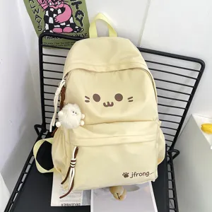 Cute cartoon yellow canvas backpack for school girls casual daypack with plush pendant.