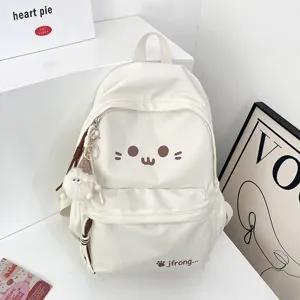 Cute white canvas backpack for school girls with cartoon face print and fluffy pendant charm.