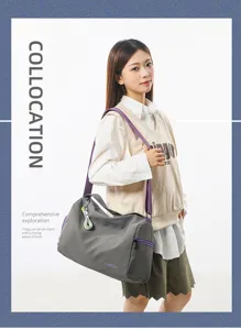Detailed view of the stylish grey gym bag with purple straps carried by a model outdoors.