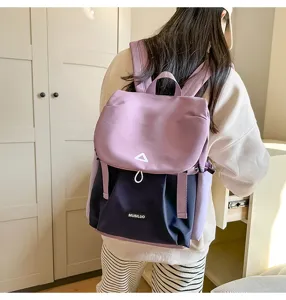 Color-blocked backpack detail, showing purple and dark blue fabric with sturdy straps.