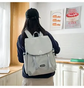 Detailed lifestyle view of casual campus commuter backpack in a stylish light gray tone.