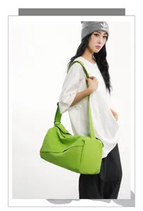 Green sports duffel bag detail, water-resistant fitness travel crossbody bag view.