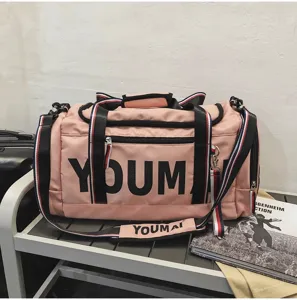 Pink sports duffel bag detail view, large capacity gym travel bag with shoe compartment.