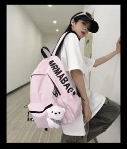 Korean style pink canvas backpack with cute bear pendant, casual student school bag for daily use.