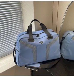 Light blue travel duffel bag with durable handles, shoulder strap, and stylish reflective stripes.