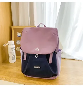 Color-matching backpack detail showing purple flap, dark blue body, and triangle logo.