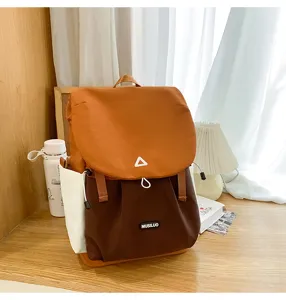Details of the stylish color-block backpack, featuring spacious compartments and durable fabric.