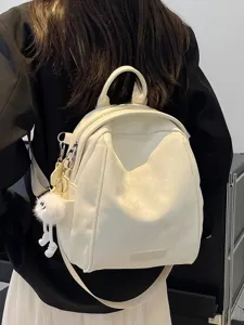 Stylish white leather backpack for women, trendy commuter travel daypack with cute charm.