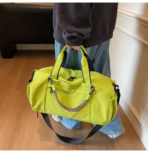Neon green gym bag detail view, showing durable waterproof fabric and adjustable straps.