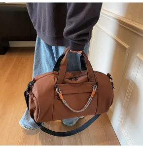 Detailed view of large capacity brown sports duffel bag with shoulder strap for travel gym.