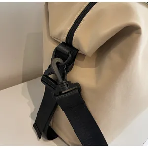Detail view of large capacity casual travel duffel bag strap buckle and zipper closure.