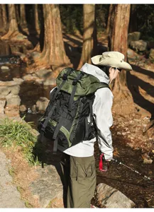 Detailed view of the large capacity waterproof outdoor hiking backpack worn in forest.