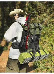 Outdoor hiking backpack detail shot in forest, showing large capacity and side attachments.