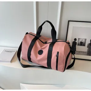 Pink sports duffel bag with black straps and side zipper pocket, perfect for gym and travel.