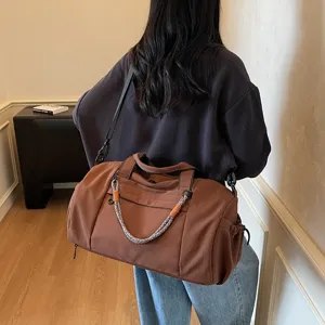 Brown large capacity sports gym bag, waterproof travel duffel bag with shoulder strap.
