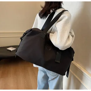 Detailed lifestyle view of a large capacity black travel duffel bag for fitness and yoga.