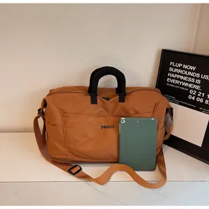Large capacity brown travel duffel bag detail, lightweight luggage with shoulder strap.