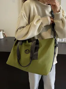 Large capacity green canvas travel duffel bag with shoulder strap for casual fitness trips.