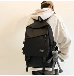 Lässiger großer schwarzer Schulrucksack mit süßem Puppenanhänger für tägliche Reisen und Büro