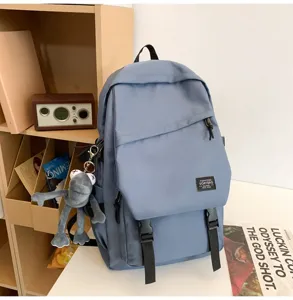 Blauer Freizeit-Rucksack mit KAWS-Stil Anhänger, große Kapazität Student Reise Schultertasche.
