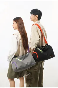 Men carrying stylish color-blocking travel gym shoulder bags in a clean studio scene.