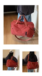 Large capacity travel duffel bag for fitness and sports, stylish red gym bag with shoulder strap.