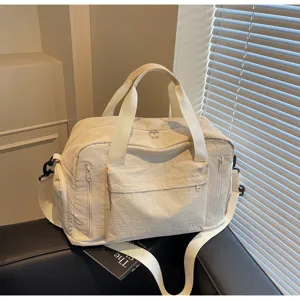 Detailed view of the large capacity travel fitness duffel bag featuring multiple zipper pockets.