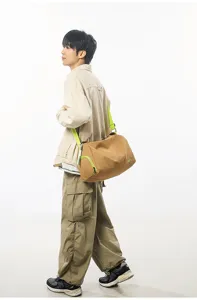 Close-up detail of the stylish travel duffel bag showcasing vibrant green straps and durable fabric.