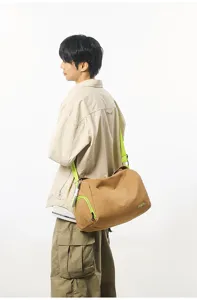 Stylish men's travel duffel bag, large capacity khaki gym bag with neon green straps.