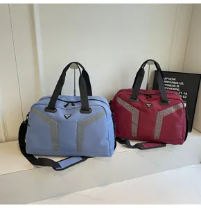Detailed view of large capacity travel duffel bags in blue and red with reflective details.