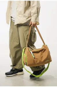 Detail view of stylish color-blocked gym shoulder bag with spacious capacity and neon green straps.